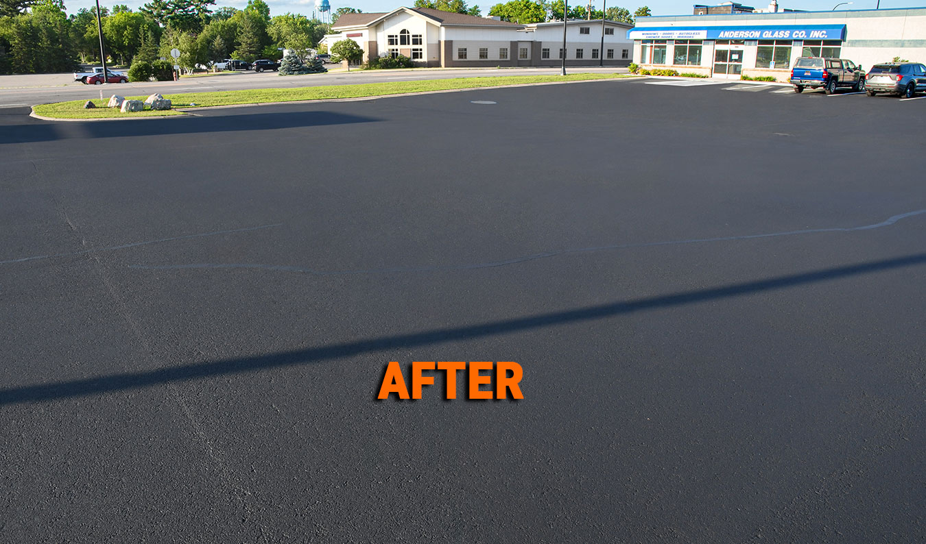 Business parking lot after professional sealcoating and crack sealing by Commercial Asphalt Repair in Grand Rapids, Minnesota.